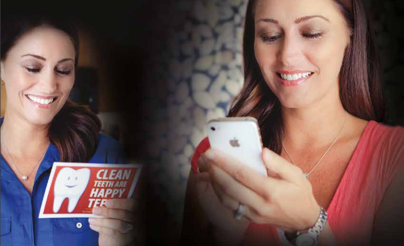 Woman looking at smartphone and postcard